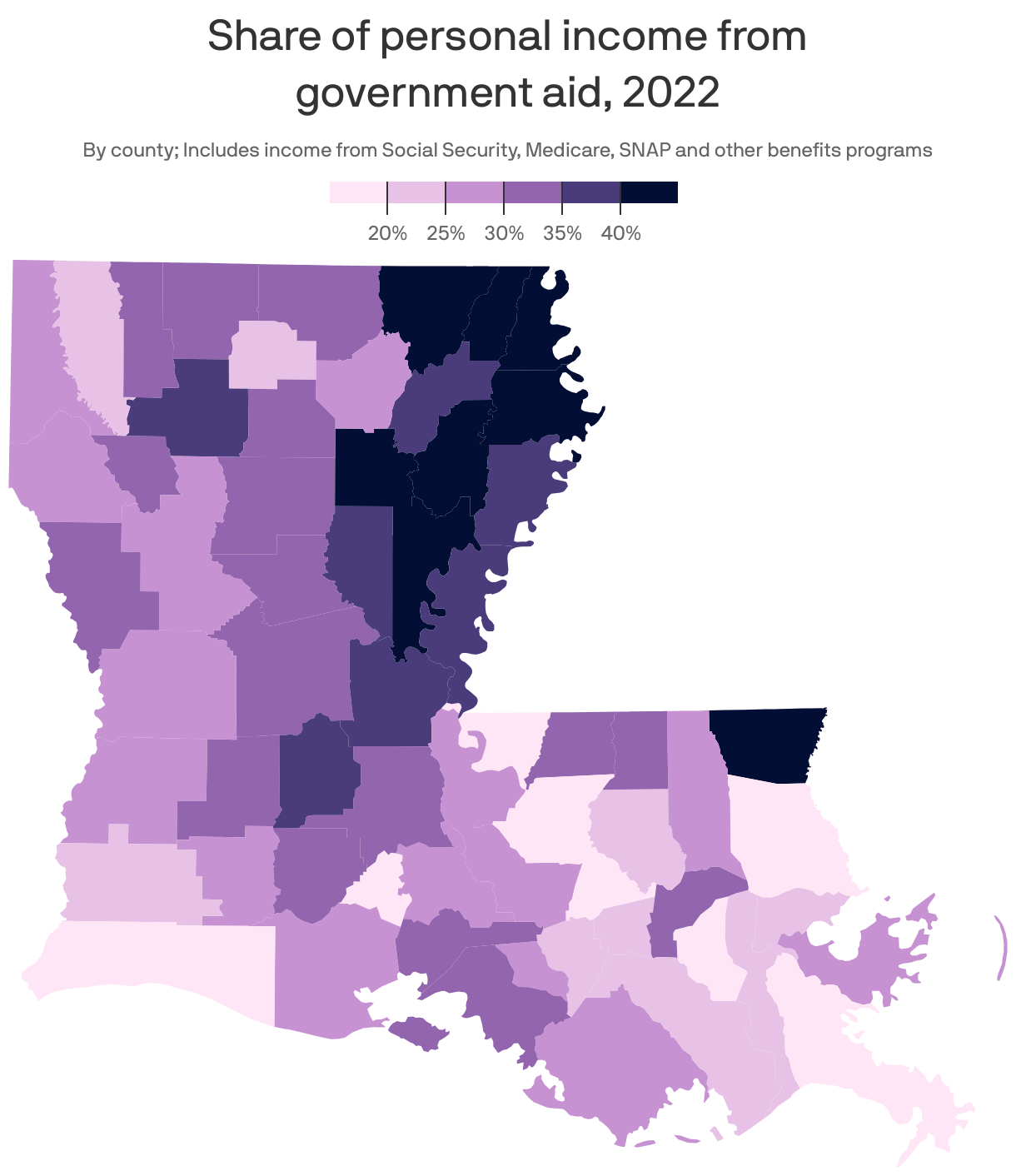 Choropleth map of U.S. counties showing the share of total personal income coming from government aid in 2022. Overall, counties in the Southern U.S., as well as rural counties, had a higher reliance on benefits programs like Social Security and Medicare compared to counties in the Northeast and Rust Belt. West Virginia counties had the highest average share, at 25.4%, while Connecticut had the lowest, at 12%. Louisiana had an average of 21%.